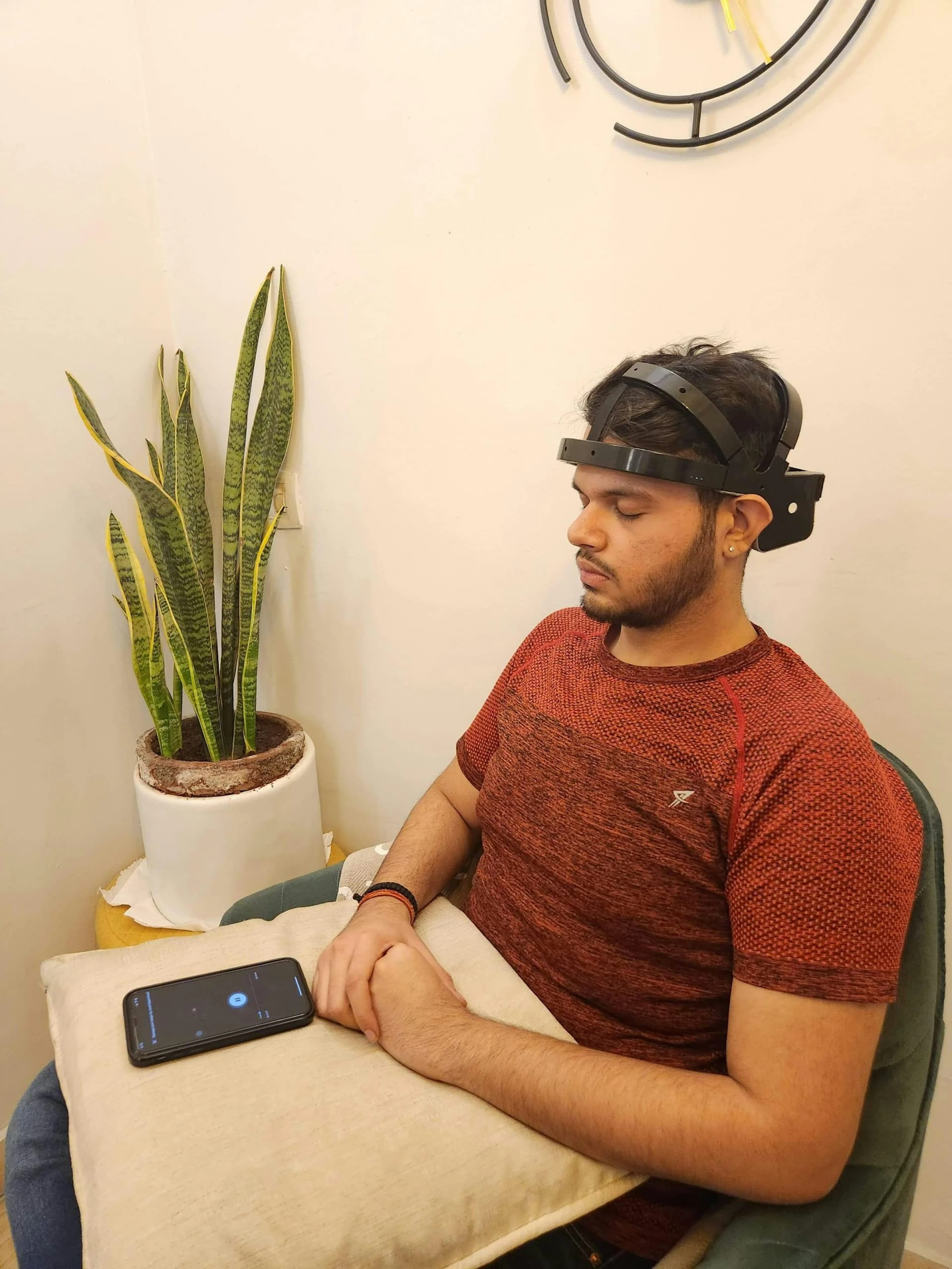 Pilot wearing EEG sensor array integrated into flight helmet while operating a high-fidelity cockpit simulator, with real-time neural signal visualization on an adjacent monitoring display.
